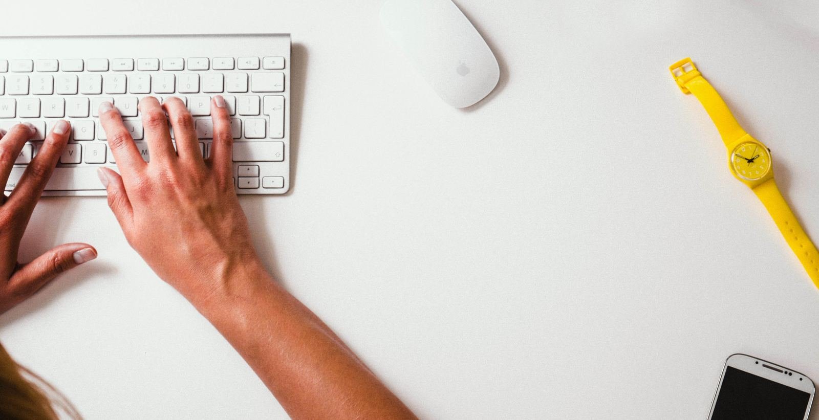 Hands typing at a keyboard, building out a business model